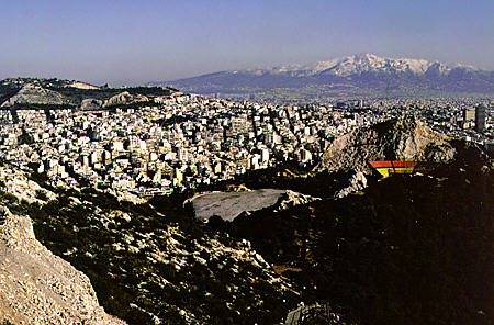 View of Athens and snow covered mountains from Likavitos Hill. Greece.