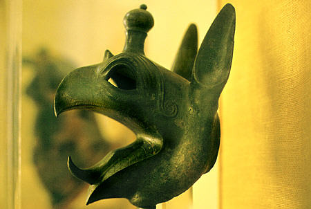 Bronze griffin head used as cauldron attachment from first half of 7th century BC at Delphi Museum. Greece.