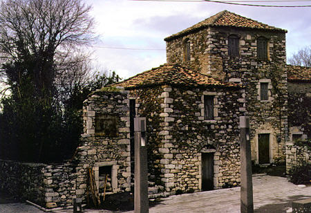 Stone houses on main square of Thalamas in Messiniakos Bay. Greece.