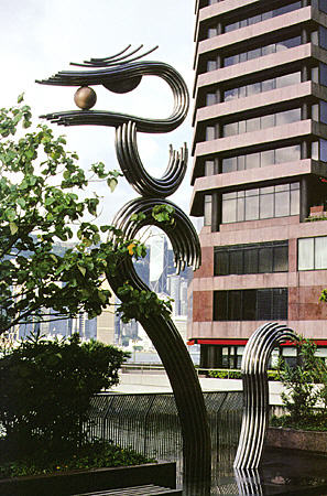 Modern sculpture of dragoon on Kowloon with Hong Kong in background. Hong Kong.