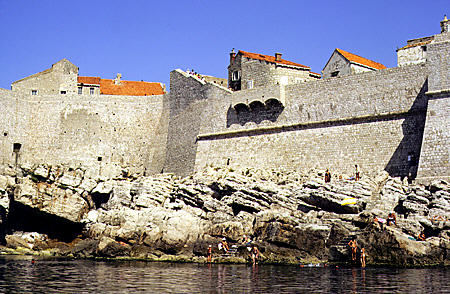 Jagged rocks encircle outer walls of old Dubrovnik. Croatia.