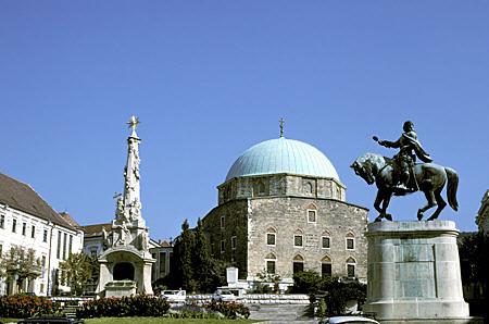 Széchenyi Tér in Pécs with Trinity Plague Column, Equestrian statue of Janos Hunyadi (c1956) and Belvarosi Templom. Hungary.