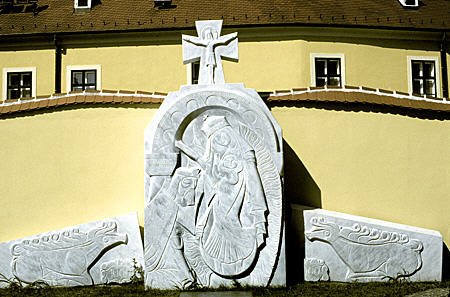 Modern religious sculpture on St Peter Church plaza in Györ. Hungary.