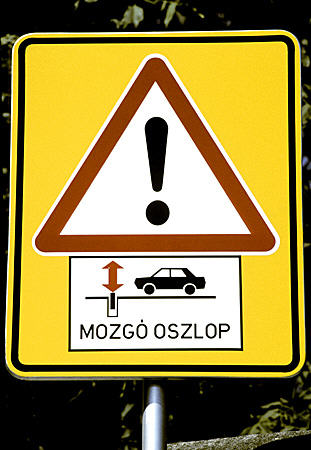Warning sign about post which raises & lowers to block traffic in Györ. Hungary.