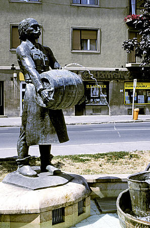 Fountain of man with beer barrel in Sopron. Hungary.