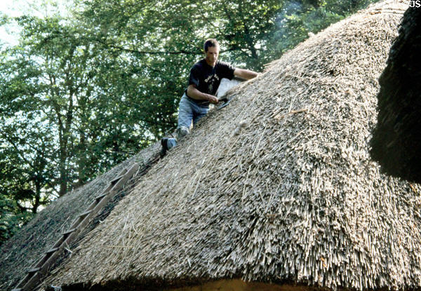 Roof thatching at Bunratty folk park. Ireland.