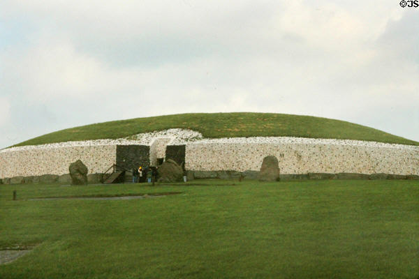 Newgrange passage tomb (3200 BCE) with restored white stone exterior. Ireland.