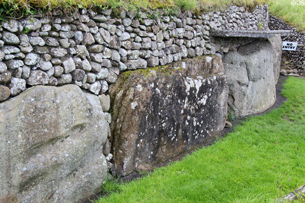 Passage tomb carved stones circumference of base at Newgrange. Ireland.