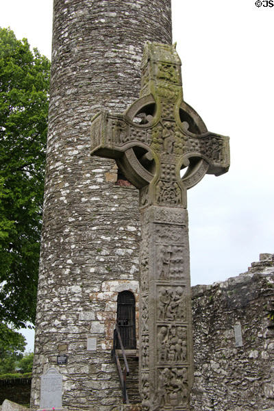 Muiredach's high cross seen before round tower at Monasterboice. Ireland.