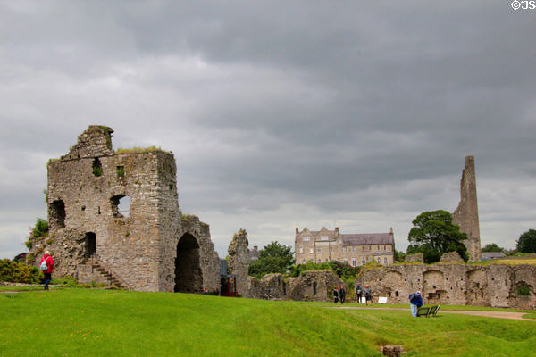 Trim Castle wall ruins with St Mary's Abbey tower ruins beyond. Trim, Ireland.