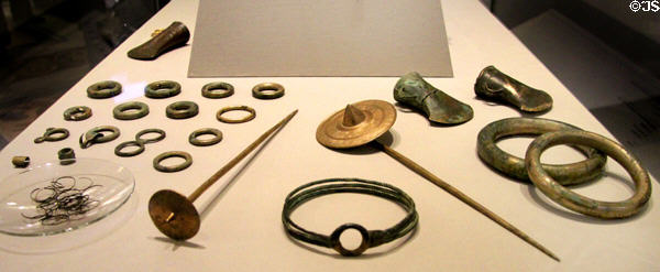 Hoard of bronze axeheads, rings, ornaments & gold-foil covered sunflower pins (c800-700 BCE) from Ballytegan at National Museum of Ireland Archaeology. Dublin, Ireland.