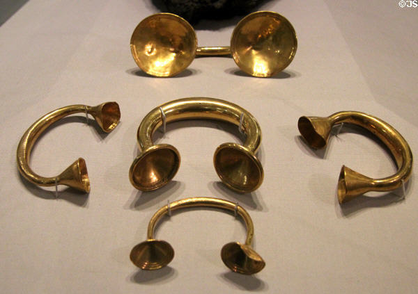 Hoard of gold dress fasteners (circular ends) & bracelets (conical ends) (c800-700 BCE) from New Ross at National Museum of Ireland Archaeology. Dublin, Ireland.