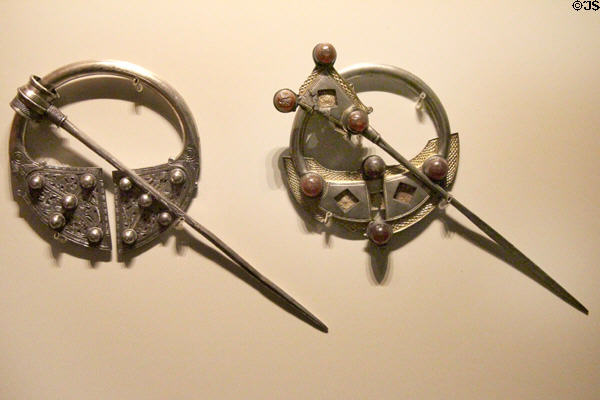 Silver Irish brooches - penannular (late 9th-early 10thC) from Kilkenny & annular (9thC) from Tipperary at National Museum of Ireland Archaeology. Dublin, Ireland.
