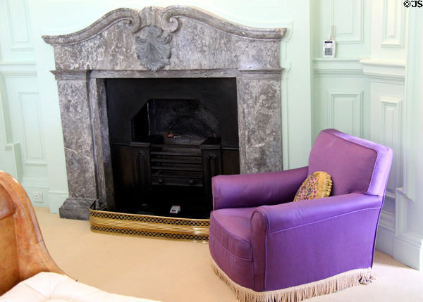 Bedroom fireplace with purple armchair at Russborough House. Ireland.