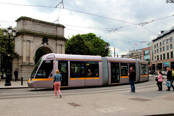 Dublin tram rounds Royal Fusiliers Arch at St Stephen's Green. Dublin, Ireland.