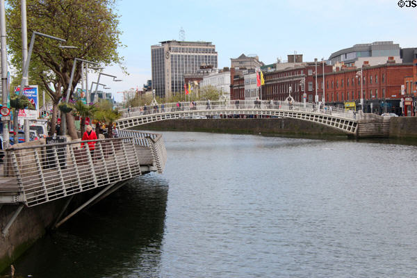 Ha'penny Bridge over River Liffey with cantilevered walkways over water. Dublin, Ireland.