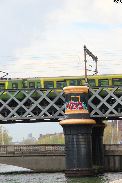 Commuter train on Loopline rail bridge over River Liffey. Dublin, Ireland.