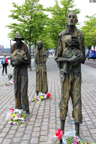 Sculpture (1997) of victims of Great Famine (1845-9) in which a million Irish died & a million more emigrated at Custom House Quay Famine Monument. Dublin, Ireland.
