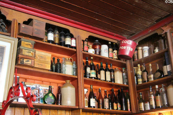 Liquor bottles & vintage shop items on shelves at Dick Mack's Pub in Dingle. Dingle, Ireland.