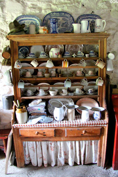 Cupboard filled with tableware at Kissane's farm at Muckross Traditional Farms in Killarney National Park. Killarney, Ireland.