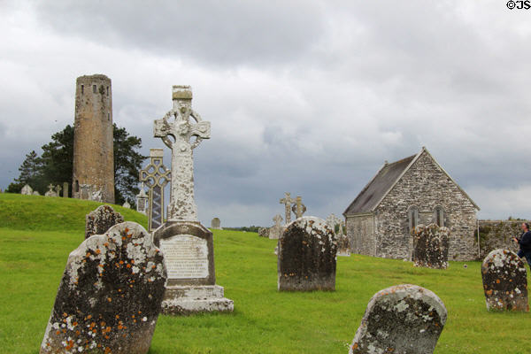 O'Rourke's Round tower over Celtic crosses at Clonmacnoise. Ireland.