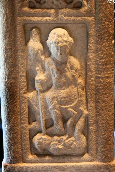 Carved panel of St Anthony or St Michael defeating devil on north edge of Cross of Scriptures at Clonmacnoise museum. Ireland.