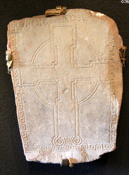 Grave slab with cross with rectangles at Clonmacnoise museum. Ireland.