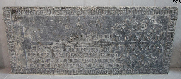 Tomb slab (1400s) engraved with blackletter inscription left incomplete because of error during carving at Medieval Mile Museum. Kilkenny, Ireland.
