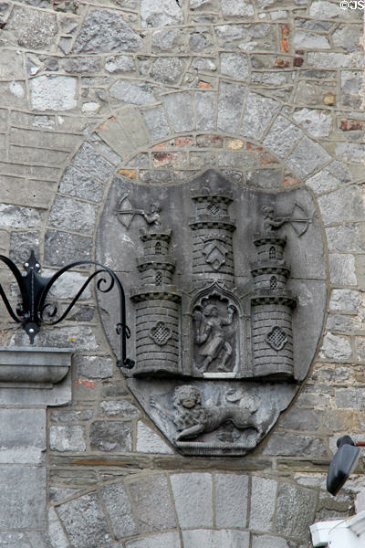 Carved coat of arms with archers atop castle on Kilkenny city hall. Kilkenny, Ireland.