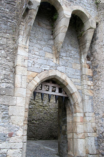 Portcullis with projecting stonework overhang used to support mechanism to raise the defensive door at Cahir Castle. Cahir, Ireland.
