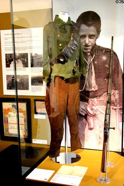 German Mauser rifle as smuggled by IRA (1921), IRA bandolier (1921) & IRA linked boy-scout uniform (1920) at Bishop's Palace. Waterford, Ireland.