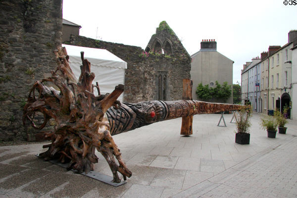 Viking sword carved from fallen fir tree (2017) by John Hayes near Reginald's Tower where an original sword (850 CE) which inspired this sculpture is displayed. Waterford, Ireland.