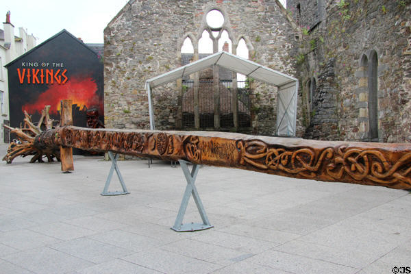 Gothic church ruins on Bailey's New St. with Viking sword sculpture featuring designs from several sources by John Hayes, longest wood carving in world. Waterford, Ireland.