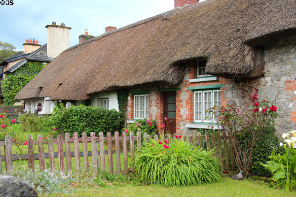 Row of thatched roof cottages (1826) on main street. Adare, Ireland. Style: English Village Style.