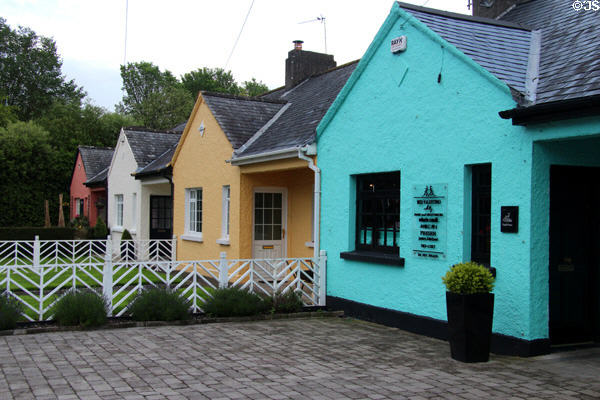 Row of slate roofed multi-colored cottages. Adare, Ireland.