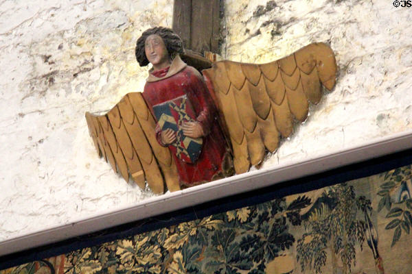 Carved figure with shield above tapestry hanging in Great Hall at Bunratty Castle. County Clare, Ireland.
