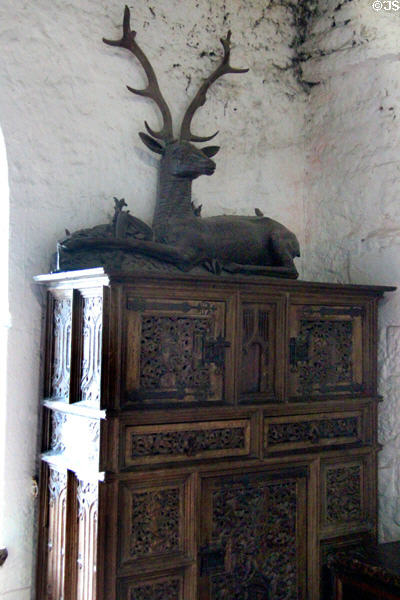 Ornately carved cupboard topped by statue of a stag in Earl's private apartments at Bunratty Castle. County Clare, Ireland.