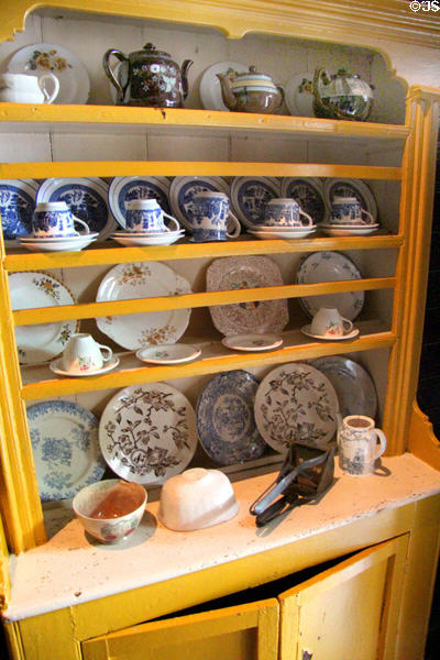 Open cupboard with dishes in Loop Head House at Bunratty Castle & Folk Park. County Clare, Ireland.