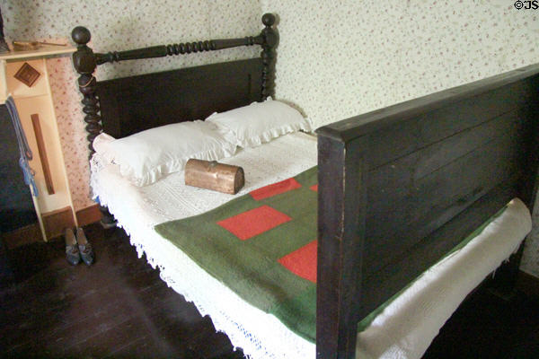 Double bed with spool headboard in Mountain Farmhouse at Bunratty Castle & Folk Park. County Clare, Ireland.