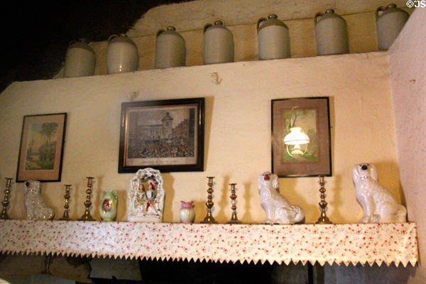 Earthenware jugs lined on mantel in Golden Vale Farmhouse at Bunratty Castle & Folk Park. County Clare, Ireland.