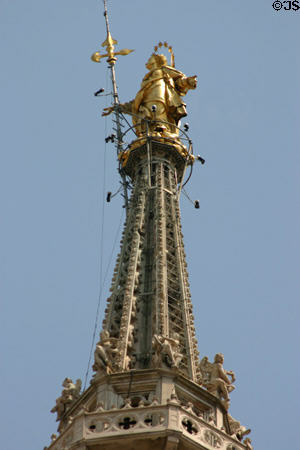 Statue of Madonna (1774) with halo of stars on Duomo central tower. Milan, Italy.