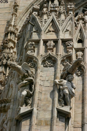 Saints with gargoyles on Duomo. Milan, Italy.
