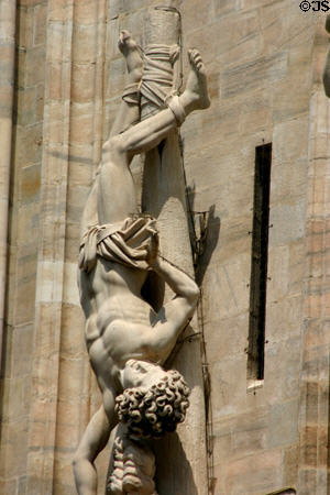 Saint crucified upside-down on Duomo. Milan, Italy.