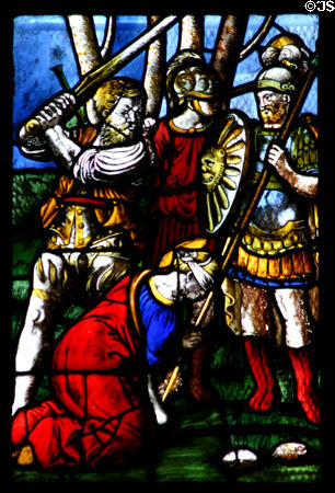 Beheading a saint in stained-glass scene in Duomo. Milan, Italy.