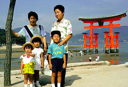 Japanese family posing near a Torii, Miya-jima. Japan.
