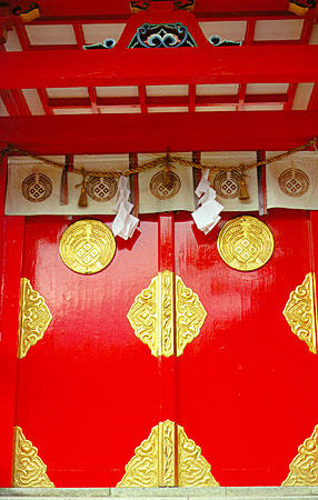 Red painted and golden-hinged doors of the Torii Temple, Tsuwano. Japan.