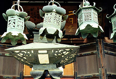 Metal temple lanterns hang in Nara. Japan.
