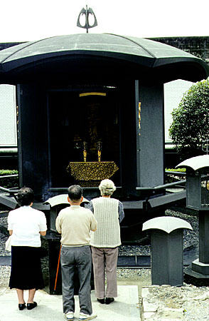 Paying tribute to ancestors at the Nishi Otani Mausoleum in Kyoto. Japan.