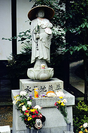 Offerings of candy, balloons and toys at a child's marker in a Kyoto cemetery. Japan.