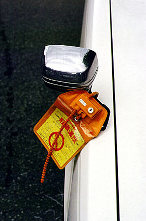 Parking ticket locked to the car until paid in Takayama. Japan.